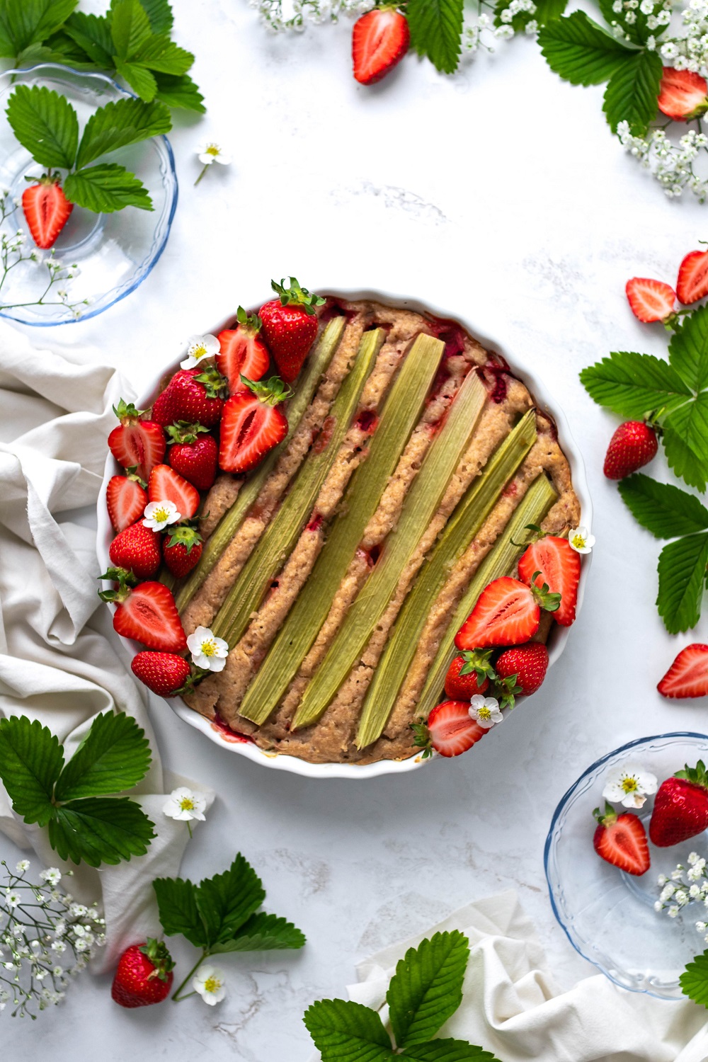 strawberry rhubarb shortcake on the table surrounded by strawberries