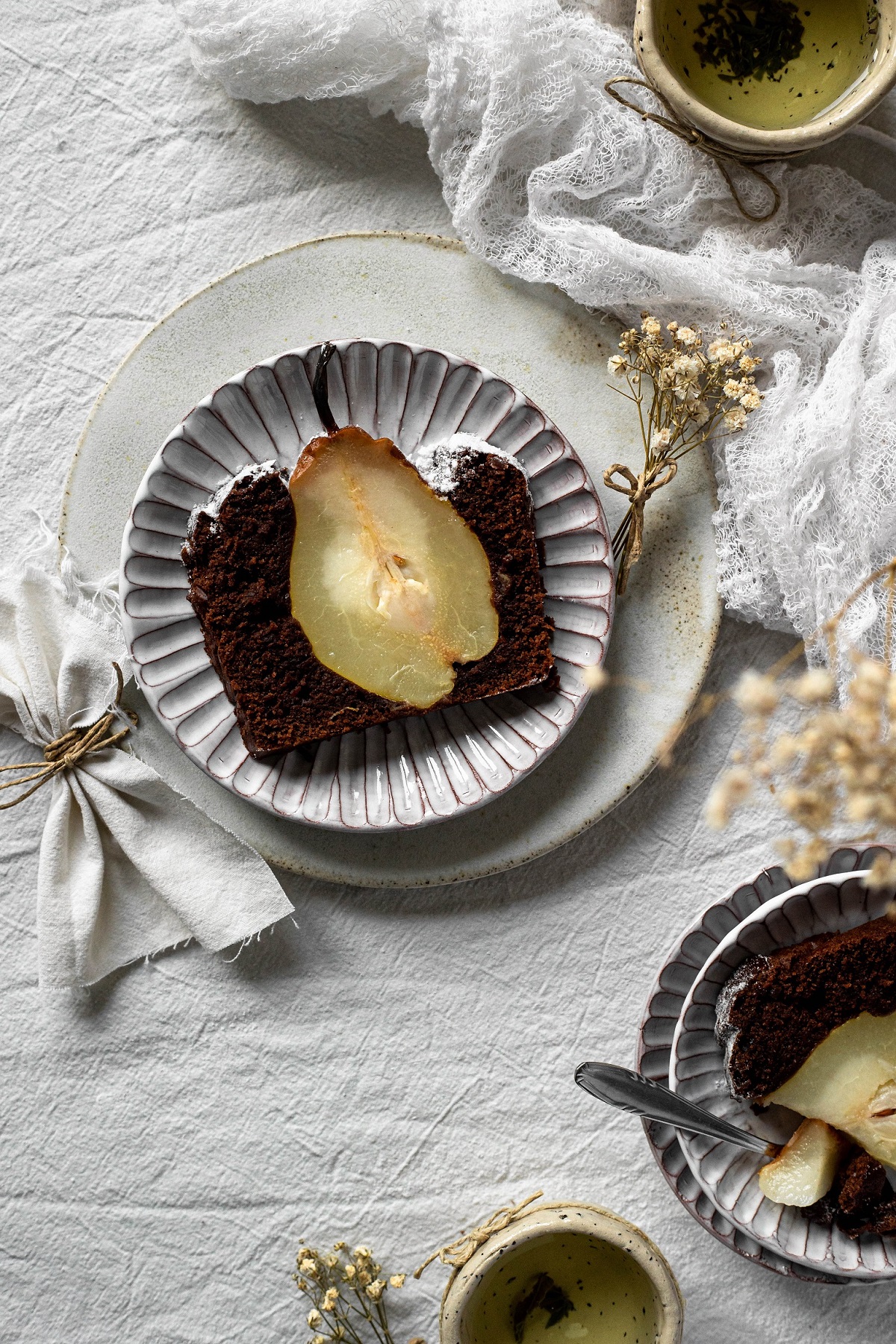 vegan chocolate pear cake sliced on a plate
