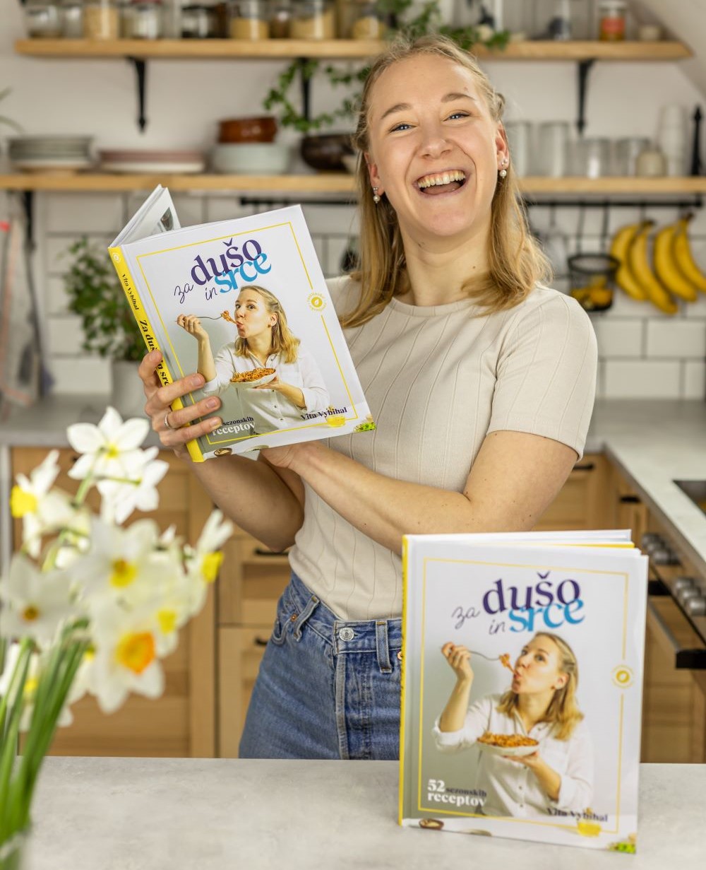 Vita-with-her-first-cookbook-smiling